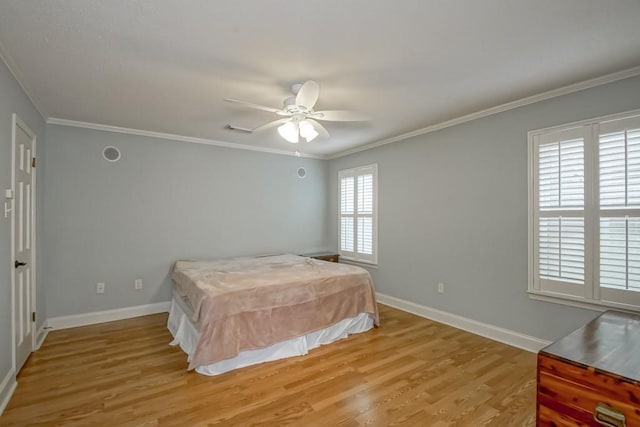 bedroom featuring ornamental molding, ceiling fan, and light wood-type flooring