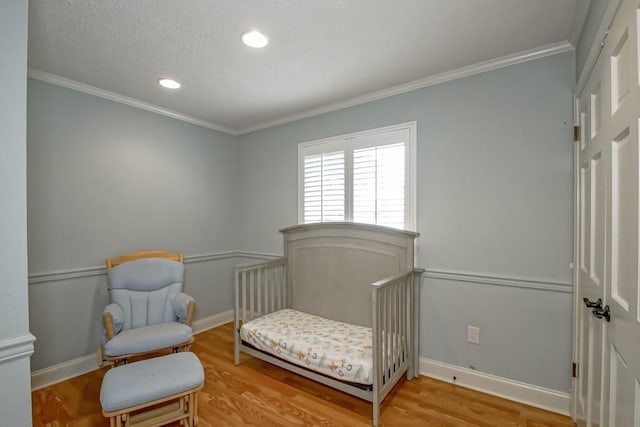 living area with ornamental molding and light wood-type flooring