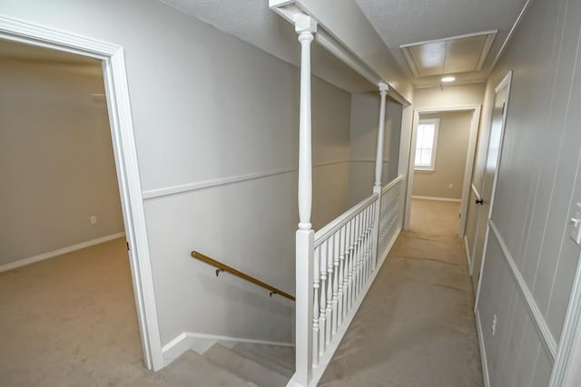 corridor featuring light colored carpet