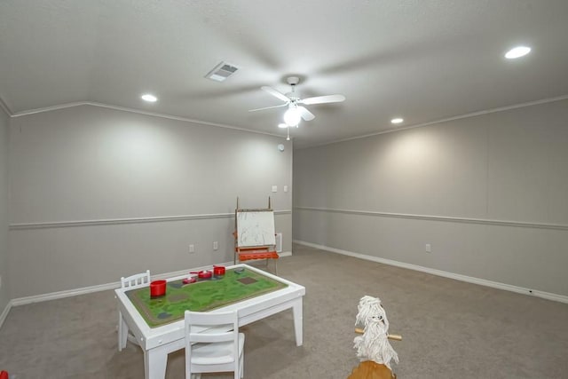 game room with vaulted ceiling, ornamental molding, carpet flooring, and ceiling fan