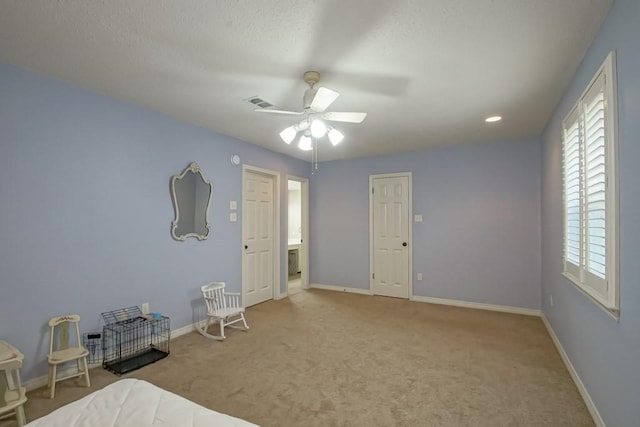 unfurnished bedroom featuring light carpet and ceiling fan