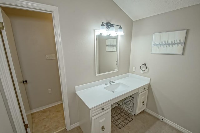 bathroom featuring vanity and lofted ceiling