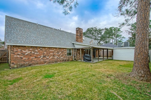 back of house featuring a patio and a lawn