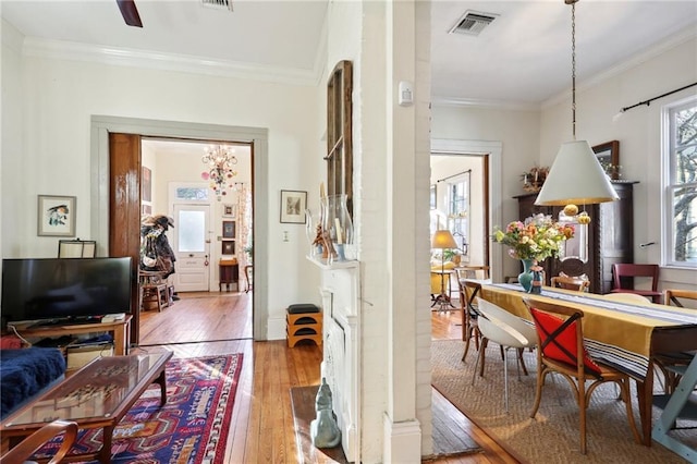 corridor featuring crown molding and light hardwood / wood-style flooring