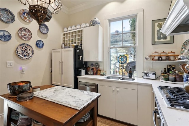 kitchen featuring crown molding, white cabinetry, appliances with stainless steel finishes, and sink