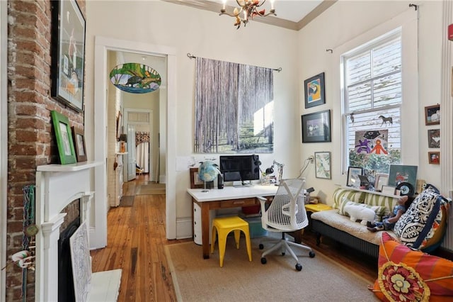 office with wood-type flooring, crown molding, and a chandelier