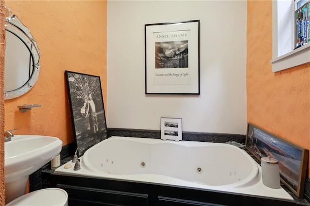 bathroom with a tub to relax in and toilet