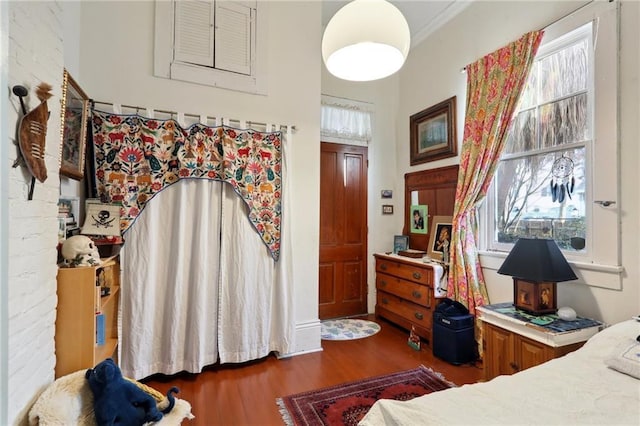 bedroom featuring ornamental molding and dark hardwood / wood-style floors