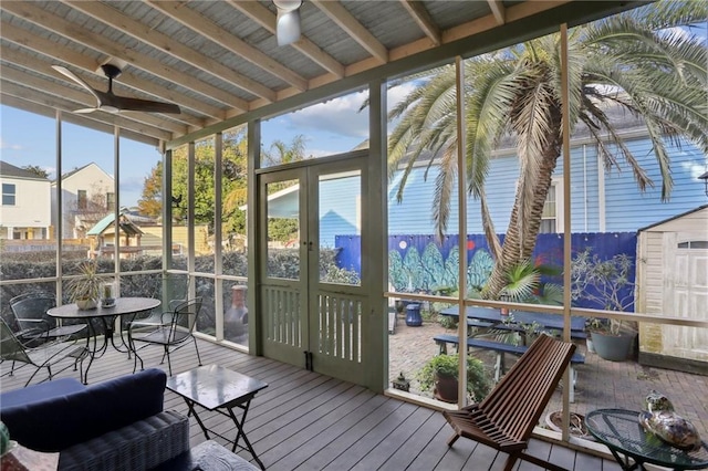 sunroom with beam ceiling and ceiling fan