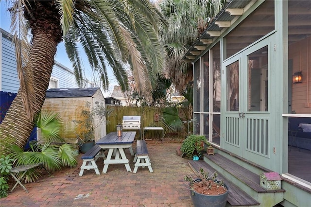 view of patio / terrace featuring area for grilling and a storage shed