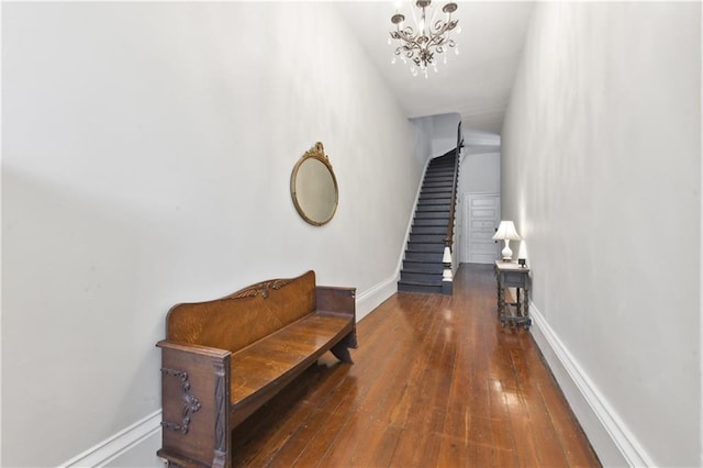 hall featuring dark hardwood / wood-style flooring and an inviting chandelier