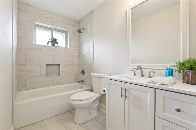 full bathroom with tiled shower / bath, vanity, and toilet