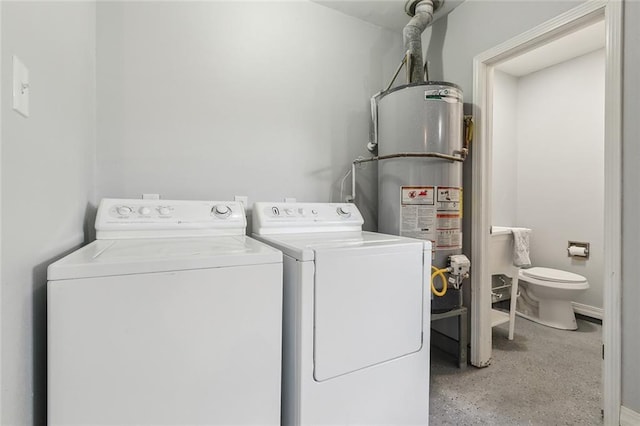 clothes washing area with gas water heater and washer and dryer