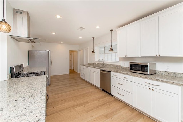 kitchen featuring pendant lighting, sink, stainless steel appliances, island range hood, and white cabinets