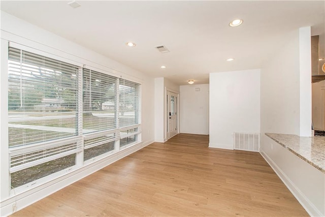 empty room with light hardwood / wood-style flooring