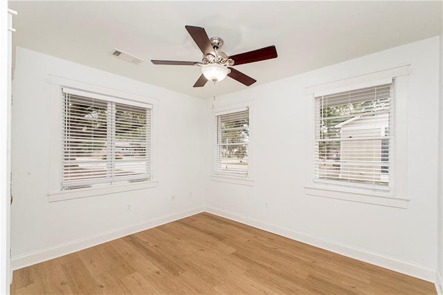 unfurnished room with hardwood / wood-style flooring, ceiling fan, and plenty of natural light