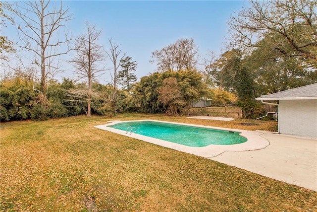 view of swimming pool with a yard and a patio