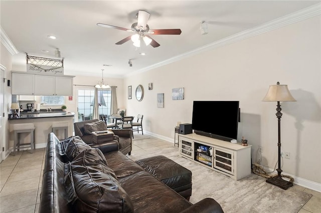 living room with ornamental molding, ceiling fan with notable chandelier, and light tile patterned floors