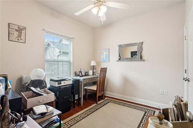 home office featuring dark wood-type flooring and ceiling fan