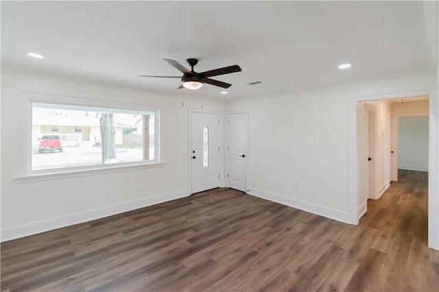 interior space with ornamental molding, dark wood-type flooring, and ceiling fan