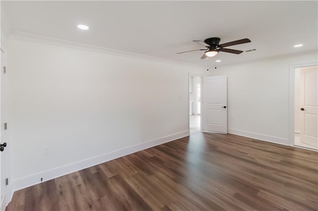 spare room with crown molding, dark hardwood / wood-style floors, and ceiling fan