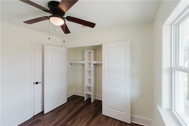 unfurnished bedroom featuring ceiling fan and dark hardwood / wood-style floors