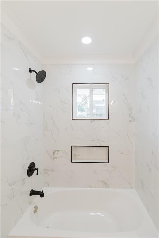 bathroom with tiled shower / bath combo and crown molding