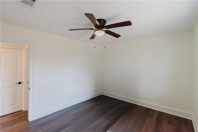 spare room featuring dark hardwood / wood-style flooring and ceiling fan