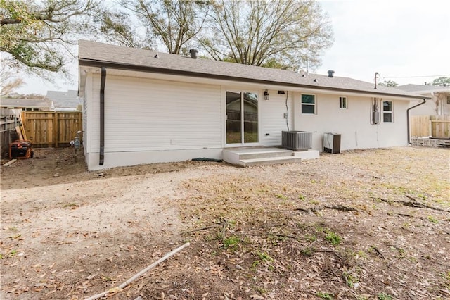 back of house featuring cooling unit