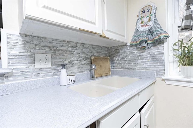 interior details featuring sink and backsplash