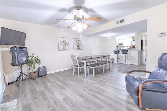 dining area featuring ceiling fan and light wood-type flooring