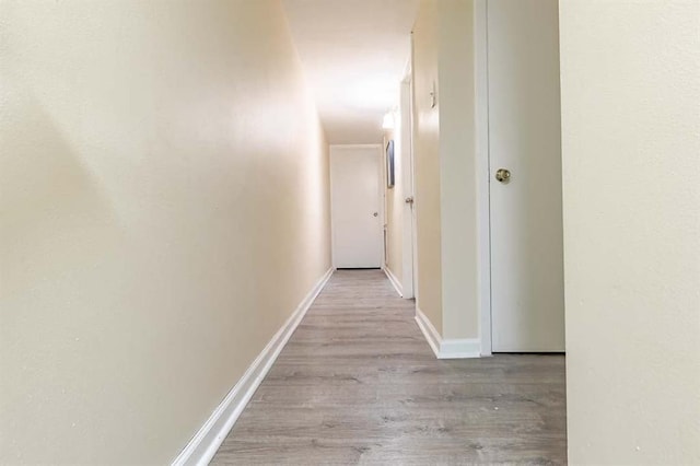 corridor with light hardwood / wood-style floors