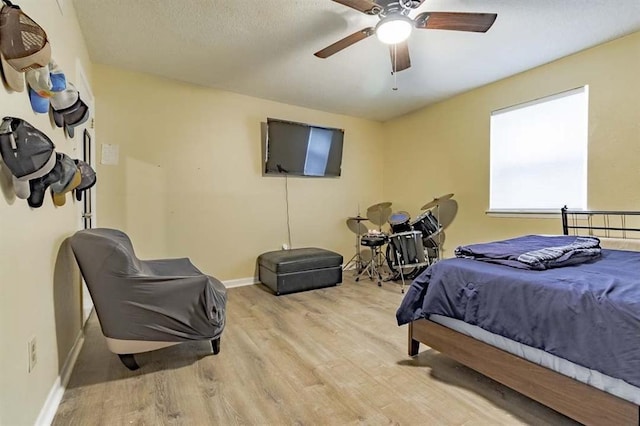 bedroom with ceiling fan and light hardwood / wood-style flooring