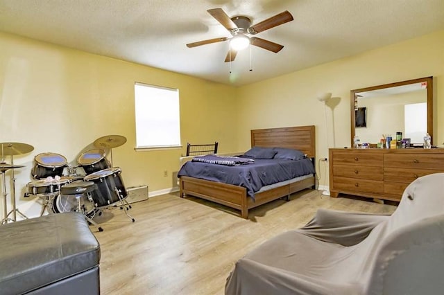 bedroom with ceiling fan and light hardwood / wood-style flooring