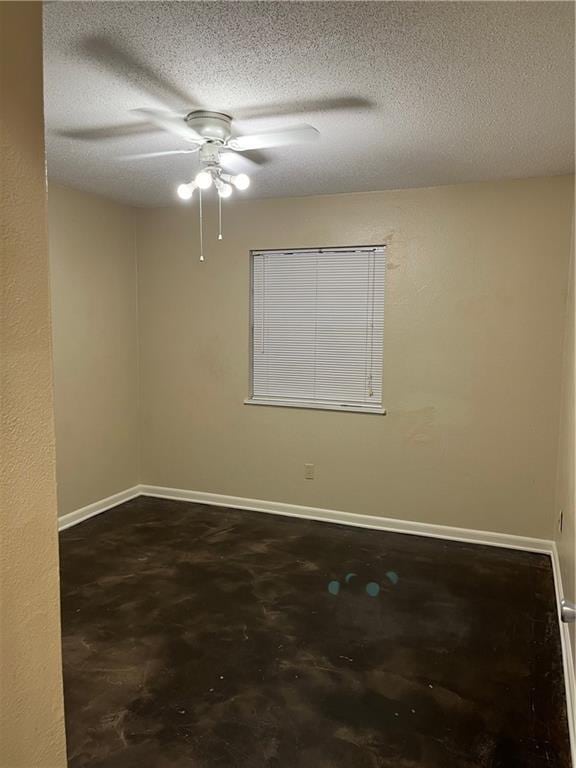 spare room with ceiling fan, concrete floors, and a textured ceiling