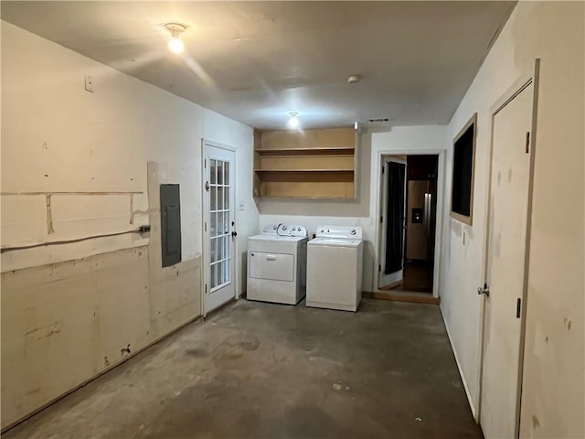 clothes washing area with electric panel and washing machine and clothes dryer