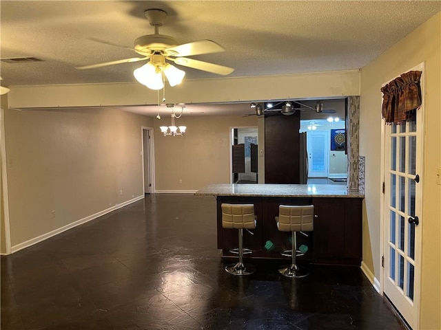 kitchen with ceiling fan and a textured ceiling