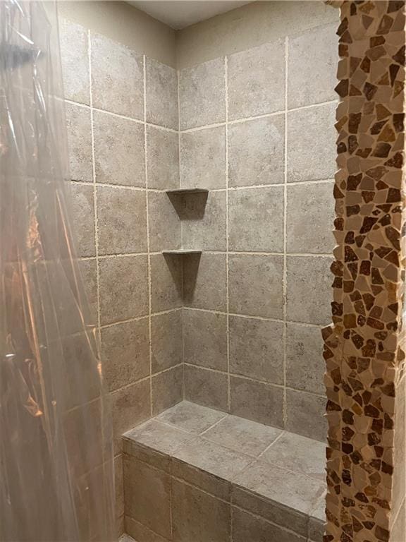 bathroom with a tile shower