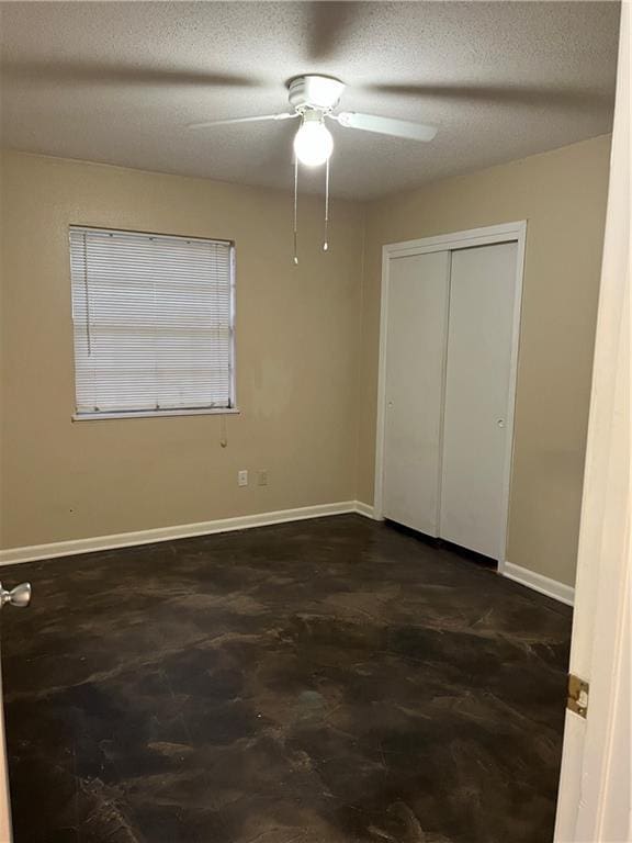 unfurnished bedroom with ceiling fan, a closet, and a textured ceiling