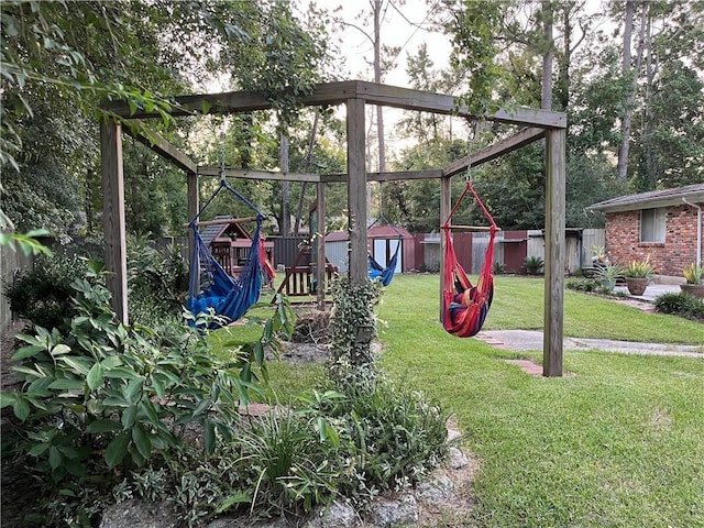 view of playground with a shed and a lawn