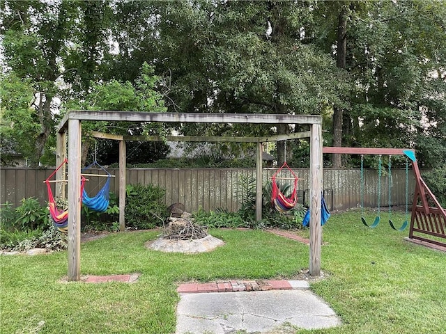 view of yard featuring a playground and an outdoor fire pit