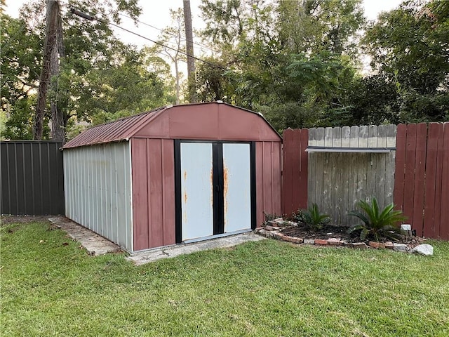 view of outbuilding featuring a yard