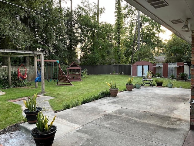 view of patio / terrace with a shed and a playground