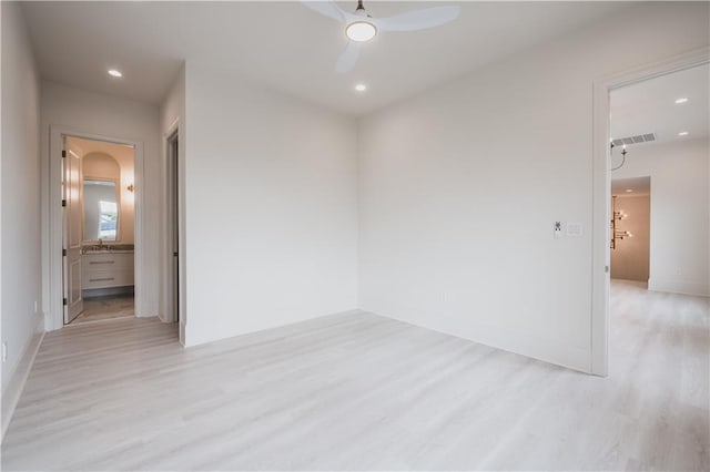 spare room with sink, light hardwood / wood-style floors, and ceiling fan