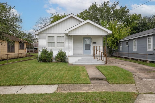 bungalow-style house featuring a front yard and covered porch