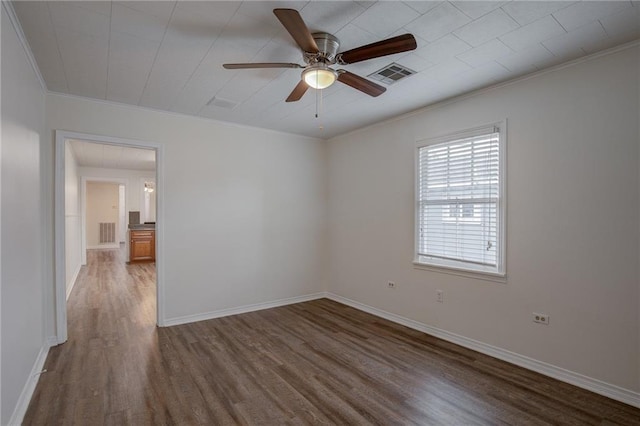 spare room featuring hardwood / wood-style flooring, crown molding, and ceiling fan