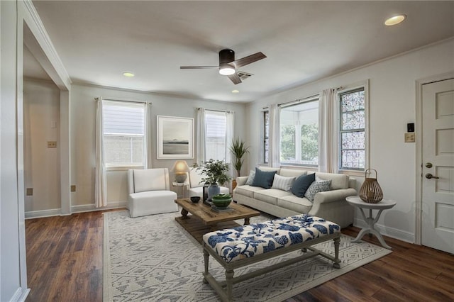 living room featuring ceiling fan, ornamental molding, dark hardwood / wood-style floors, and a healthy amount of sunlight