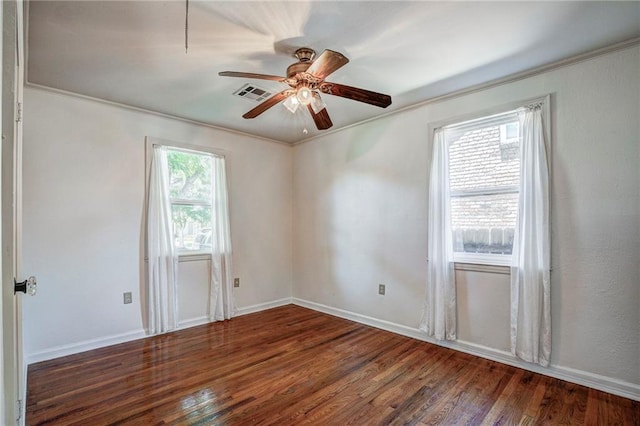 empty room with crown molding, ceiling fan, and dark hardwood / wood-style floors