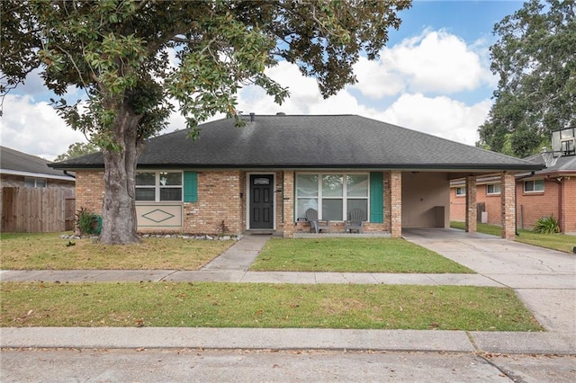 view of front of property with a carport and a front lawn