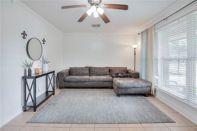 tiled living room featuring ceiling fan and ornamental molding